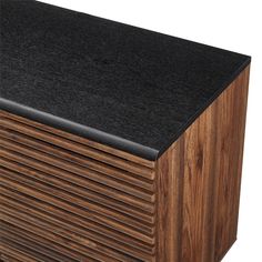 a black counter top sitting on top of a wooden cabinet