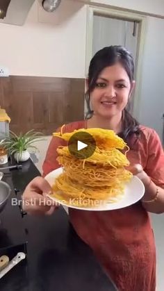 a woman holding a plate with some food on it