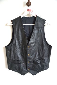 Vest details: * Black genuine leather vest * Button closure * 2 pockets * Condition: Perfect vintage condition Measurements: Length: 26" / 66 cm Armpit to armpit: 20 1/2" / 52 cm Shoulder to shoulder: 14" / 36 cm Label size: L Feel free to message me with any questions Black Leather Vest Casual, Black Leather Vest Vintage, Top Bikes, Classy Jacket, Mens Vests, Vest Outfits, Leather Vest, Western Outfits, Label Sizes