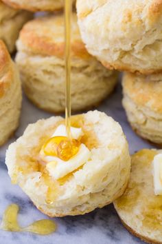 the best homemade biscuits with butter and honey on top are ready to be eaten