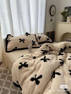 a bed with black and white comforters on it