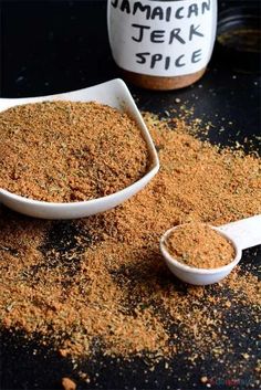 a spoon full of spice sitting on top of a table