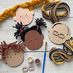 some crafting supplies are laid out on the floor with scissors and yarns around them