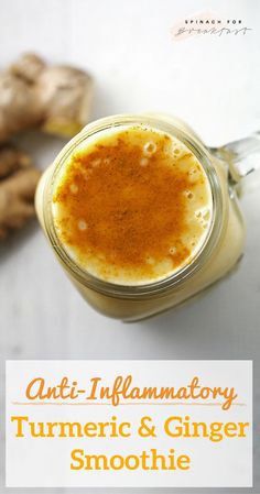 a glass jar filled with liquid next to some ginger