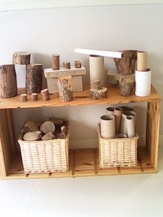 the shelves are filled with different types of wood and baskets on top of each shelf