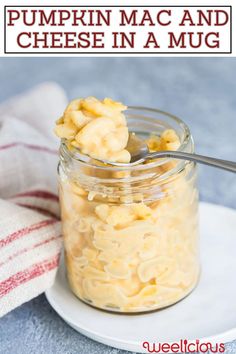 a jar filled with macaroni and cheese on top of a white plate