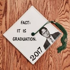 a white graduation cap with the words fact it is graduation on it and a green tassel