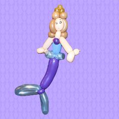 an inflatable mermaid doll floating on top of it's back legs and tail