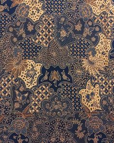 an intricate blue and gold design on fabric