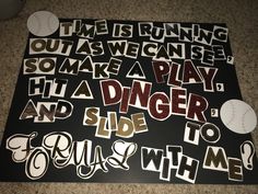 some stickers that are on top of a black board with white letters and baseballs