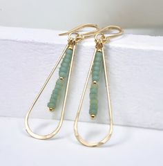 "Bring on the sun with these summer beach sea glass earrings.  The long gold hammered hoops with sea glass beads are the perfect summer accessory.  These eye-catching goldhoops are ready to turn heads and make you feel like a million bucks on the beach or anywhere. * Approximately 2.25\" long * Made with 14k Gold Filled * Sea Glass colored Seed Beads * Polished to a high shine * Handmade in Montana * Sent in a ribboned gift box with polishing cloth ----- OUR MATERIALS -----  *STERLING SILVER - E Summer Gold Wire Wrapped Hoop Earrings, Gold Wire Wrapped Hoop Earrings For Summer, Gold Teardrop Hoop Earrings For Summer, Beaded Tassels Tutorial, Beach Glass Jewelry, Sea Glass Colors, Beachglass Jewelry, Earrings Summer, Sea Glass Earrings