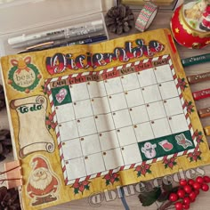 a christmas themed calendar is displayed on a table with other holiday decorations and pencils