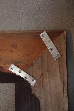 two pieces of wood with metal latches on them