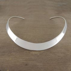 This solid open backed sterling silver choker, with its classic curved design and high polished finish is the perfect statement piece for any special occasion. If you would like this Solid Sterling Silver Classic Choker in a gold or rose gold finish, please call us and we will offer this bespoke service. You may also be interested in Statement Sterling Silver Drop Choker Necklace Made From: Sterling Silver Measurements: Necklace thickness: approx. 1.2cm. Necklace height: approx. 12.5cm Necklace width: approx. 12cm. Sterling Silver Choker Necklace, Simple Choker, Silver Necklace Simple, Women Choker Necklace, Sterling Silver Choker, Silver Choker Necklace, Womens Chokers, Earring Silver, Silver Choker