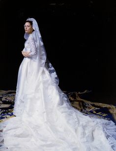 a woman in a white wedding dress and veil