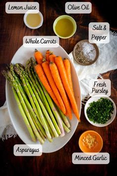 a plate with carrots, asparagus, parsley and other ingredients on it