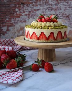 there is a cake with strawberries on the table