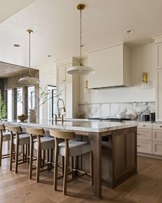 a kitchen with an island and bar stools