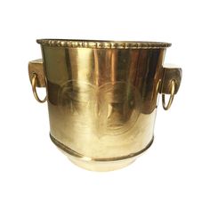 an antique brass cup with handles on a white background