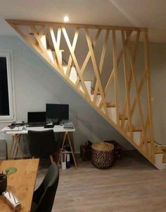 a room with a desk, chair and stairs in it