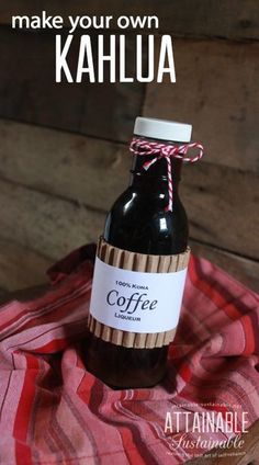 a bottle of coffee sitting on top of a red and white towel with the words make your own kahlua