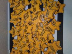 a bunch of yellow dog bone shaped cookies