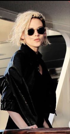 a woman with blonde hair and black sunglasses