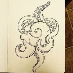 a drawing of an octopus in black and white ink on a piece of notebook paper