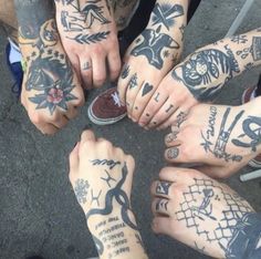 many people with tattoos on their hands and feet