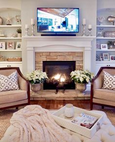 a living room filled with furniture and a flat screen tv mounted above a fire place