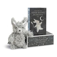 a stuffed animal next to a good night book and an open box with the cover on it