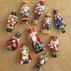 a group of christmas ornaments sitting on top of a wooden table next to each other