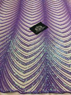 purple and white sequins on fabric