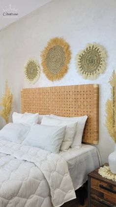 a bed with white linens and pillows in a room decorated with sunflowers