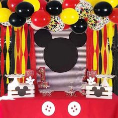 a mickey mouse themed birthday party with balloons