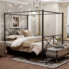 a bed room with a neatly made bed and a chandelier