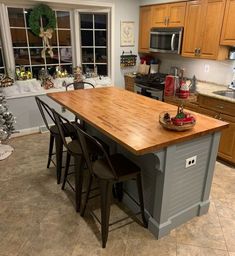 a kitchen island made out of an old table and chairs with the words diy farmhouse kitchen island above it