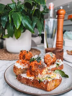 some food is sitting on a plate near a potted plant