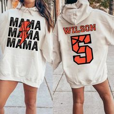 This Custom Mom Basketball Sweatshirt and custom basketball mom hoodie is perfect for showing your love and support for your child during Basketball season! The mom shirt has a cute basketball jersey style which comes with your kid's name and number on back. This basketball Mom Shirt is a perfect basketball Sweatshirt for Mom to wear for the entire basketball game day. Give any Sports Mom or basketball mama a gift she will love and use for her little ones.  ---------------------------------------------------------------------------- { S H I R T / D E T A I L S } Our sweatshirts, hoodies and t-shirts SUPER soft and SUPER comfy. They are UNISEX style! Make sure to choose your size accordingly! Please see images for sizing details. Please measure your current shirts that fit well and match up Casual Hoodie With Name Print, Casual Fall Hoodie With Name Print, Customizable Casual Sports Hoodie, Casual Customizable Hoodie For Sports Events, Casual White Hoodie With Name Print, White Casual Hoodie With Name Print, Custom Basketball Hoodie, Basketball Mom Shirts, Basketball Hoodie