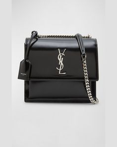 Saint Laurent "Sunset" shoulder bag in patent leather     Features signature YSL logo lettering     Sliding chain/leather shoulder strap can be doubled; removable tag     Flap top with magnetic closure    Exterior, one slip pocket under flap     Divided interior; one slip pocket     Approx. 8.7"H x 6.3"W x 2.6"D    Professional cleaning recommended    Made in Italy Ysl Crossbody Bag, Leather Chain, Patent Leather, Neiman Marcus, Crossbody Bag, Shoulder Strap, Saint Laurent, Tops Designs, Shoulder Bag