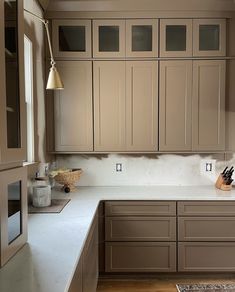 a kitchen with brown cabinets and white counter tops