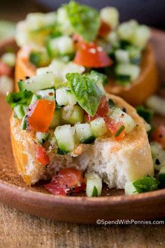 a close up of a plate of food with bread and veggies on it