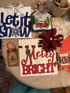 some christmas cards are on a table with doily and other items around it,