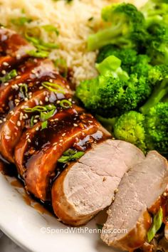 meat, rice and broccoli on a plate with sesame seed sprouts