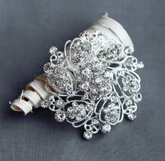 the bridal bouquet is adorned with crystal stones