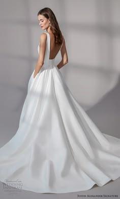 a woman in a white wedding dress is looking back