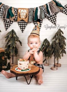 a baby is sitting in front of a cake