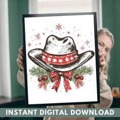 a woman holding up a christmas card with an image of a cowboy hat on it