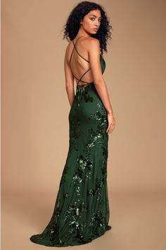 Make it a night to remember in the Lulus Valhalla Forest Green Sequin Lace-Up Maxi Dress! Sheer mesh, embellished with an eye-catching display of shiny forest green sequins, covers this gorgeous gown with a V-neckline and triangle bodice with seamed, lightly padded cups. High, empire waist flows into a figure-flaunting mermaid maxi skirt, with a slight high-low hem. Adjustable satin straps create a sultry lace-up look atop the open back, for a headturning finish. Hidden back zipper/clasp. Fit: T Green Sequin Prom Dress, Forest Green Dresses, Green Formal Dresses, Sequin Prom Dress, Formal Dresses Gowns, Cute Prom Dresses, Sequin Maxi Dress