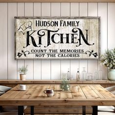 a wooden table sitting under a kitchen sign